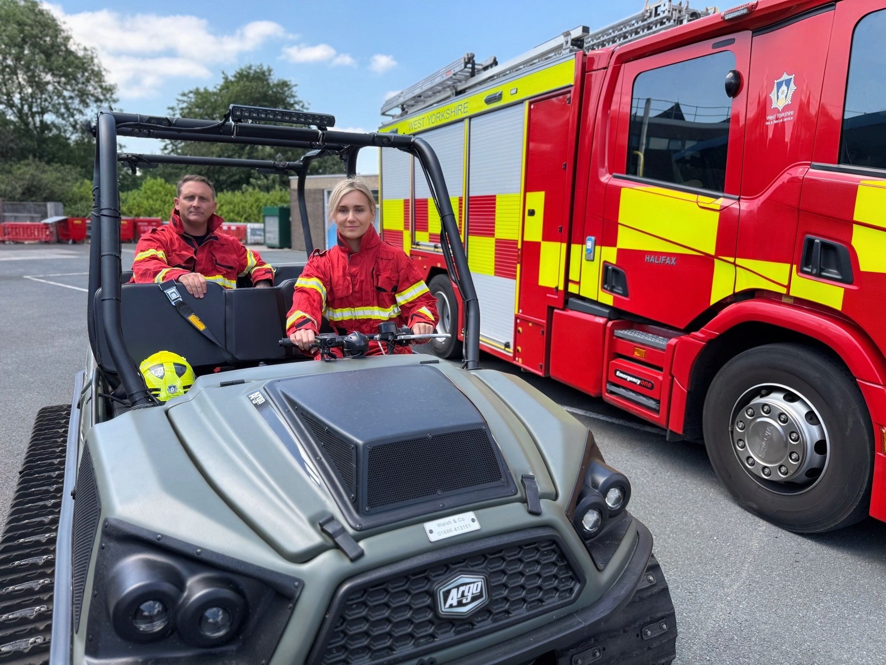 Firefighters in wildfire fire kit sitting on an ArgoCat