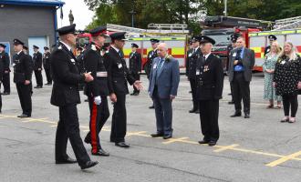 Photograph of 2021 long service ceremony, Chief Fire Officer and Lord Lieutenant talking to staff..
