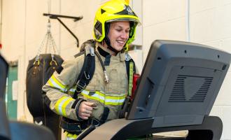 A firefighter, in full BA kit, on a treadmill