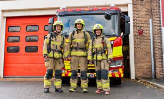 Three firefighters standing outside Morley Fire Station