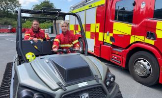 Firefighters in wildfire fire kit sitting on an ArgoCat