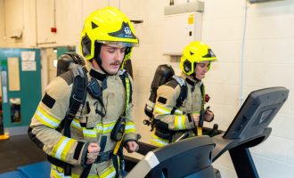 FF Moody and FF Gray in full PPE on a treadmill