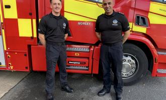 Firefighter Ben Moody and ADC Asif Mahroof outside Morley Fire Station