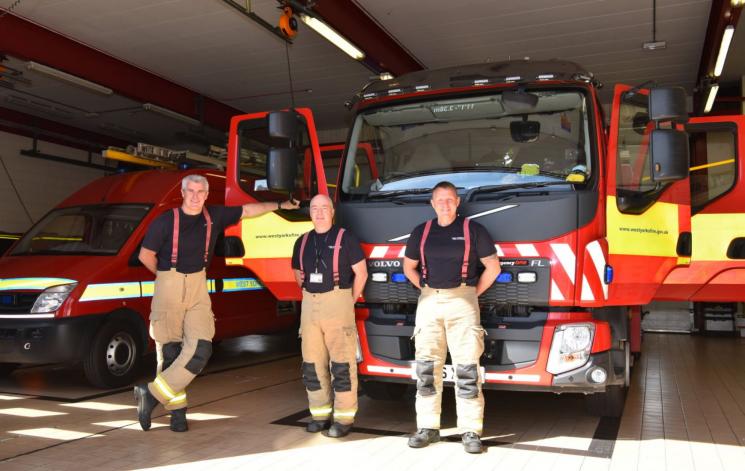 Firefighters stood in front of Fire Engine at Castleford Fire Station.