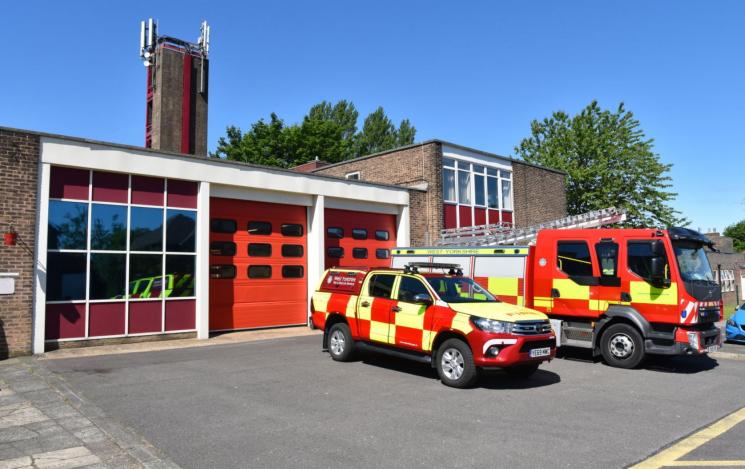 Morley Fire Station with fire car and fire engine parked outside. 