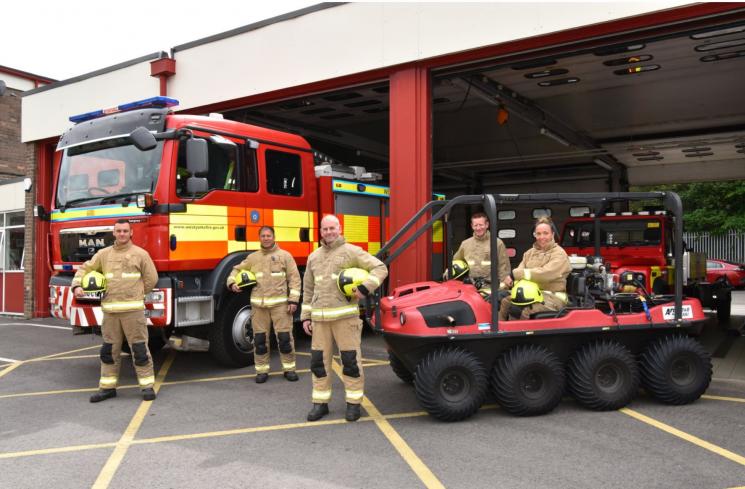 Fire crews stood outside Todmorden Fire Station with fire engine and moorland fire off road vehicle. 