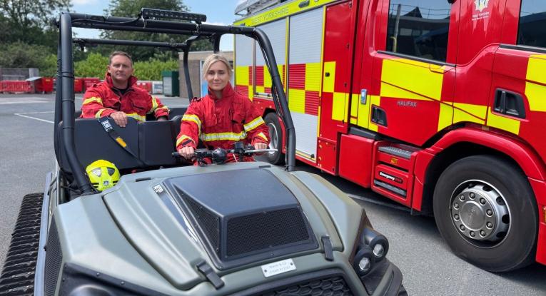Firefighters in wildfire fire kit sitting on an ArgoCat